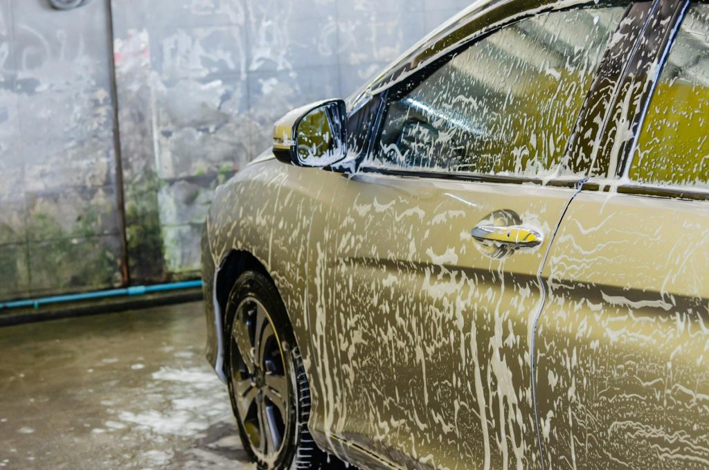 A gleaming car being professionally washed at Carwashclean car wash in Kenya